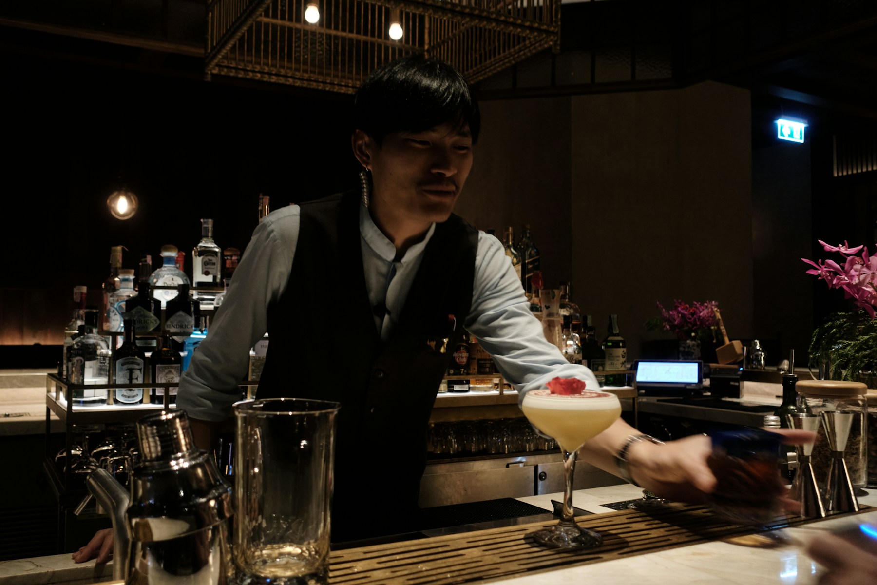 Bartender carefully preparing a cocktail