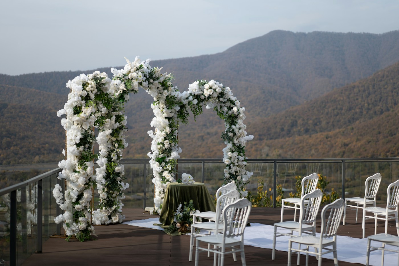 Outdoor wedding ceremony set against a mountain backdrop